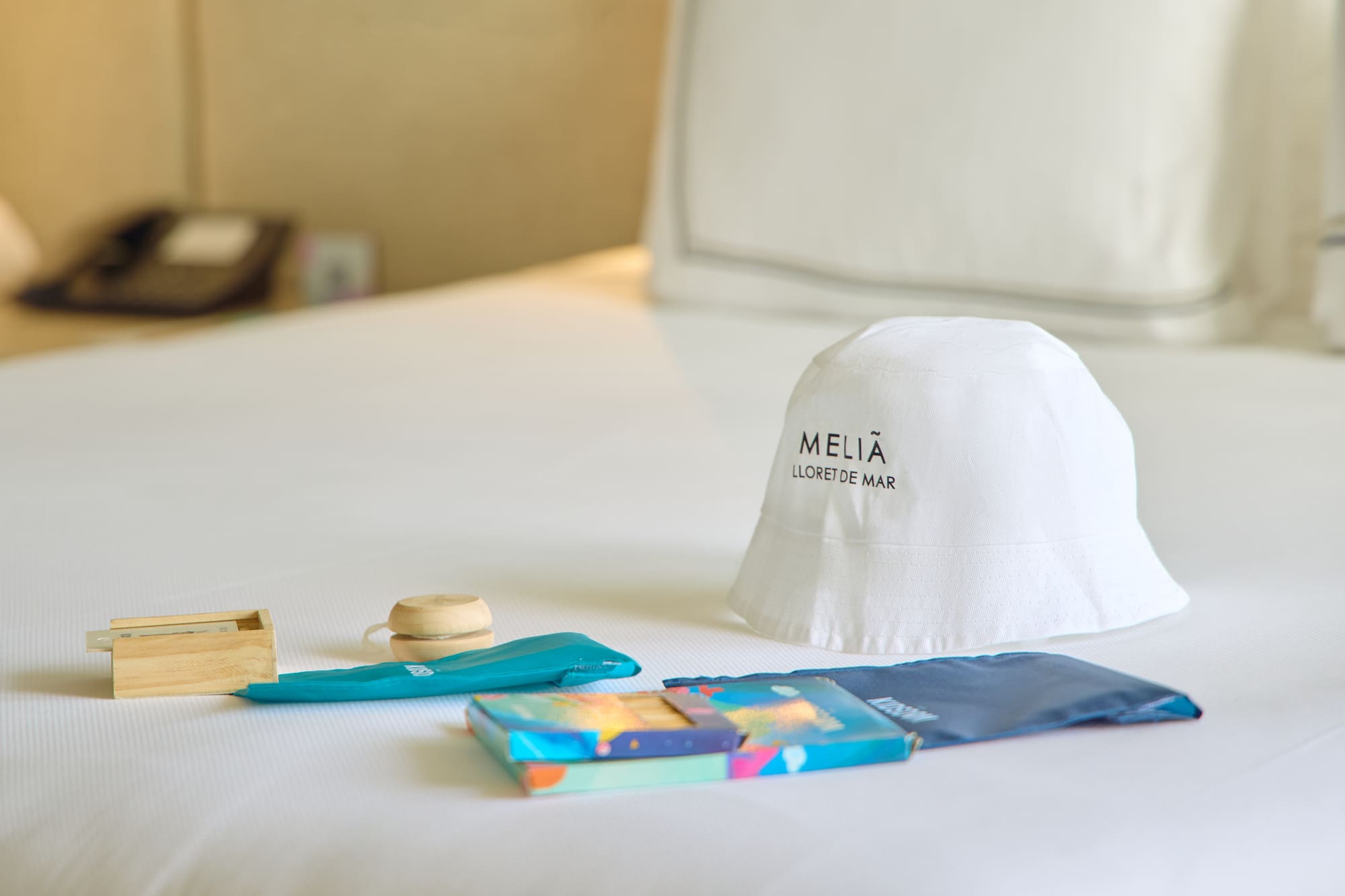 a white hat and other items on a bed