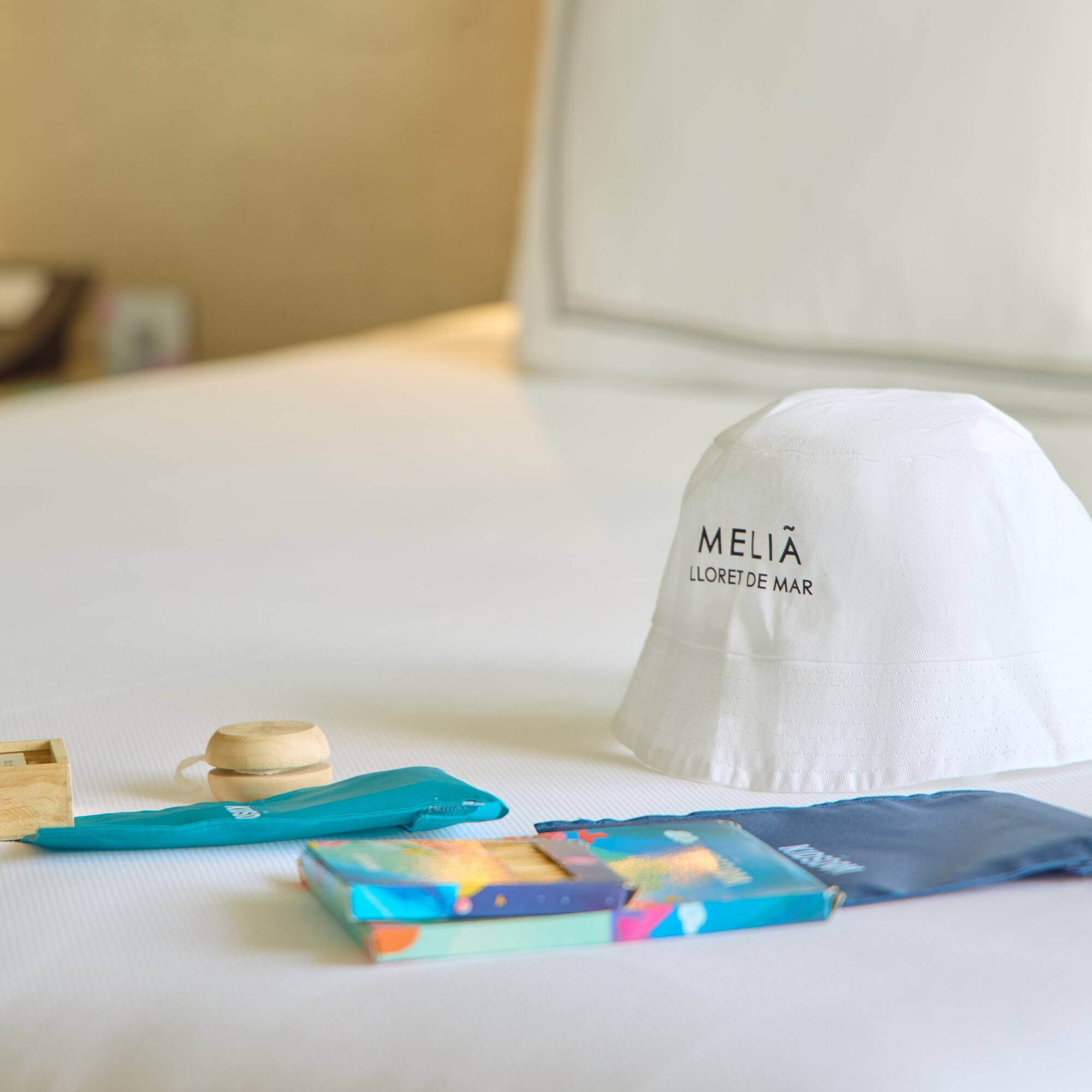 a white hat and other items on a bed