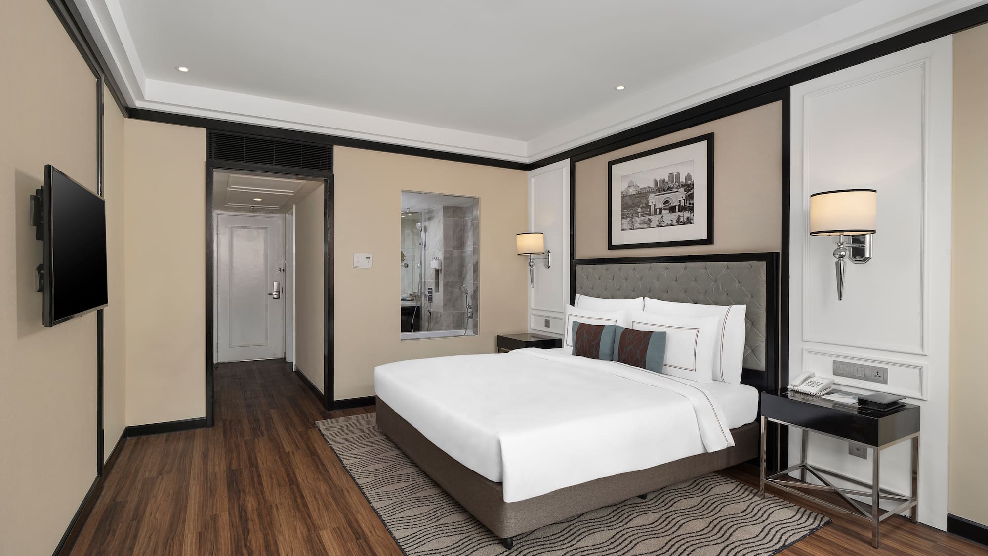 a bedroom with a bed and a wood floor