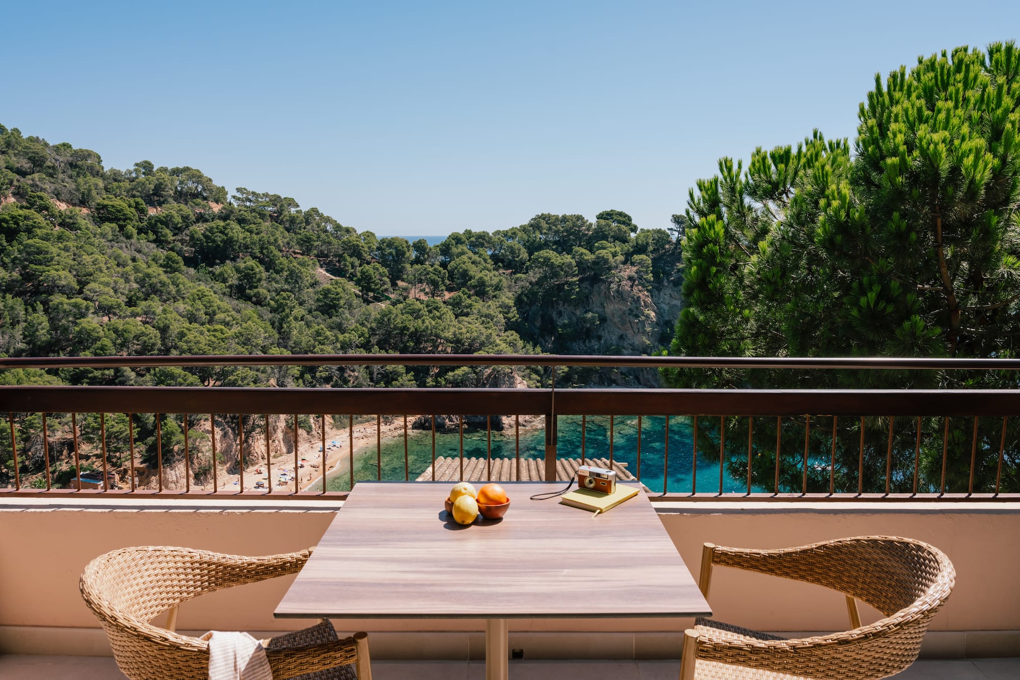 a table and chairs on a balcony overlooking a body of water