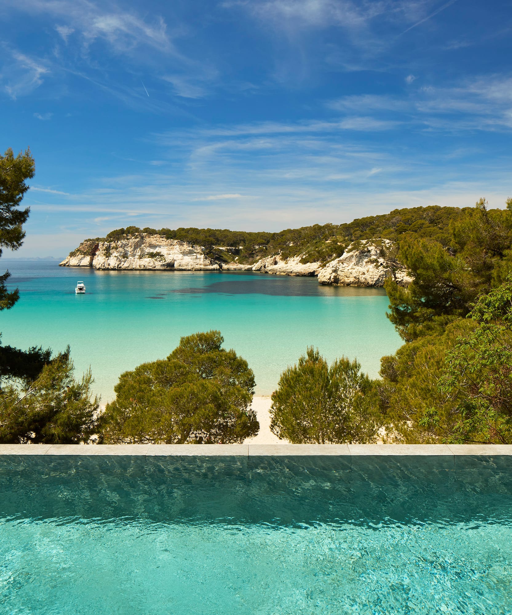 a pool overlooking a beach and trees