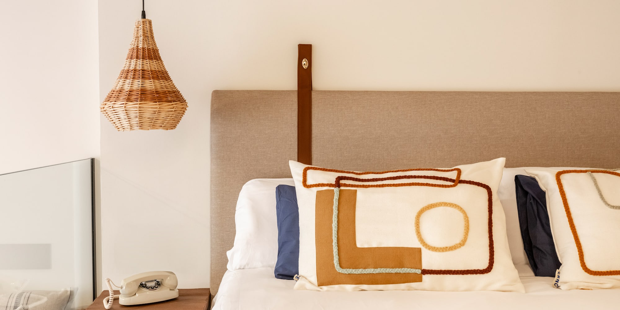 a bed with pillows and a telephone