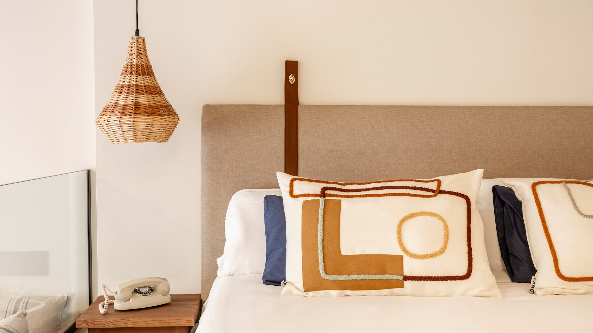 a bed with pillows and a telephone