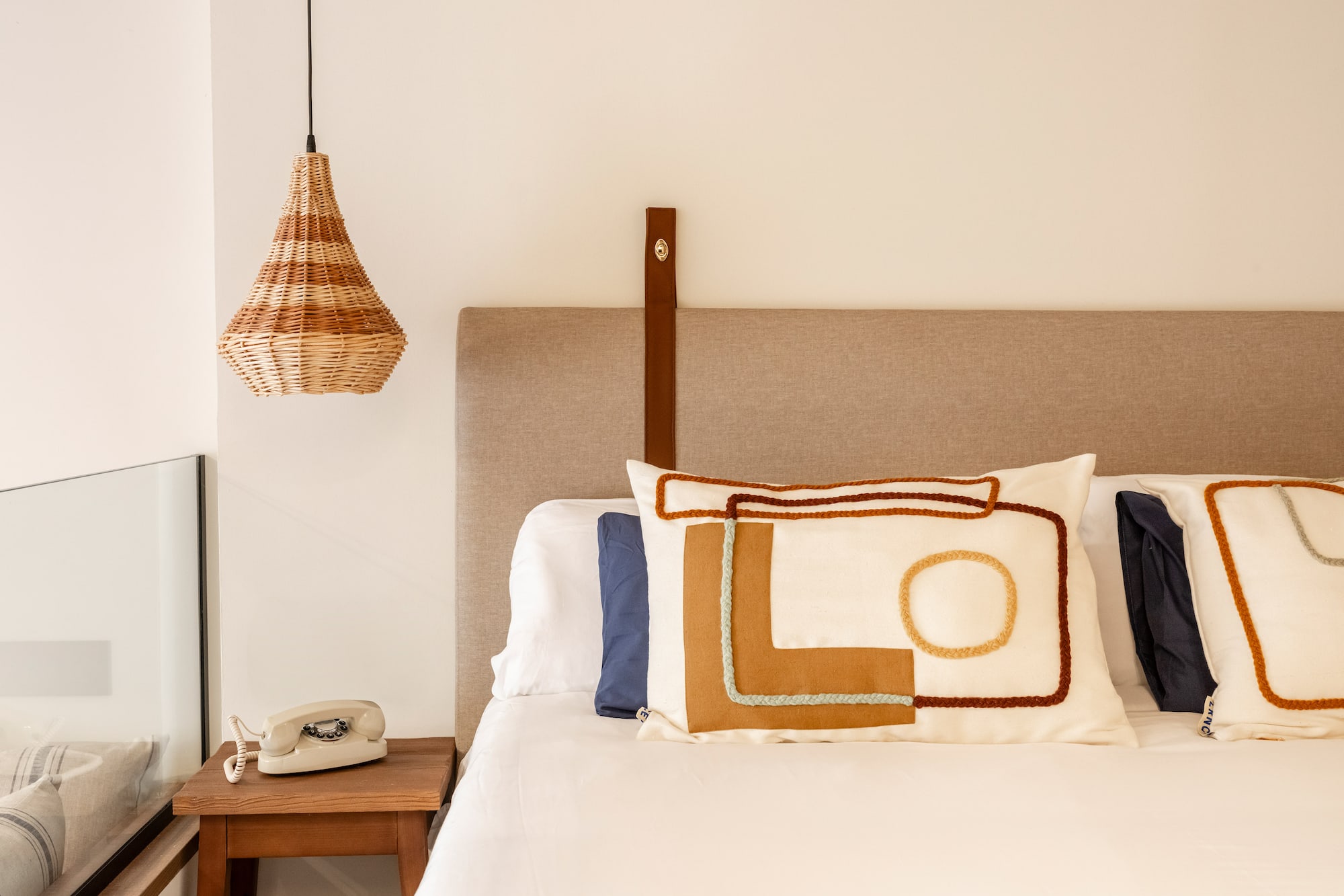 a bed with pillows and a telephone