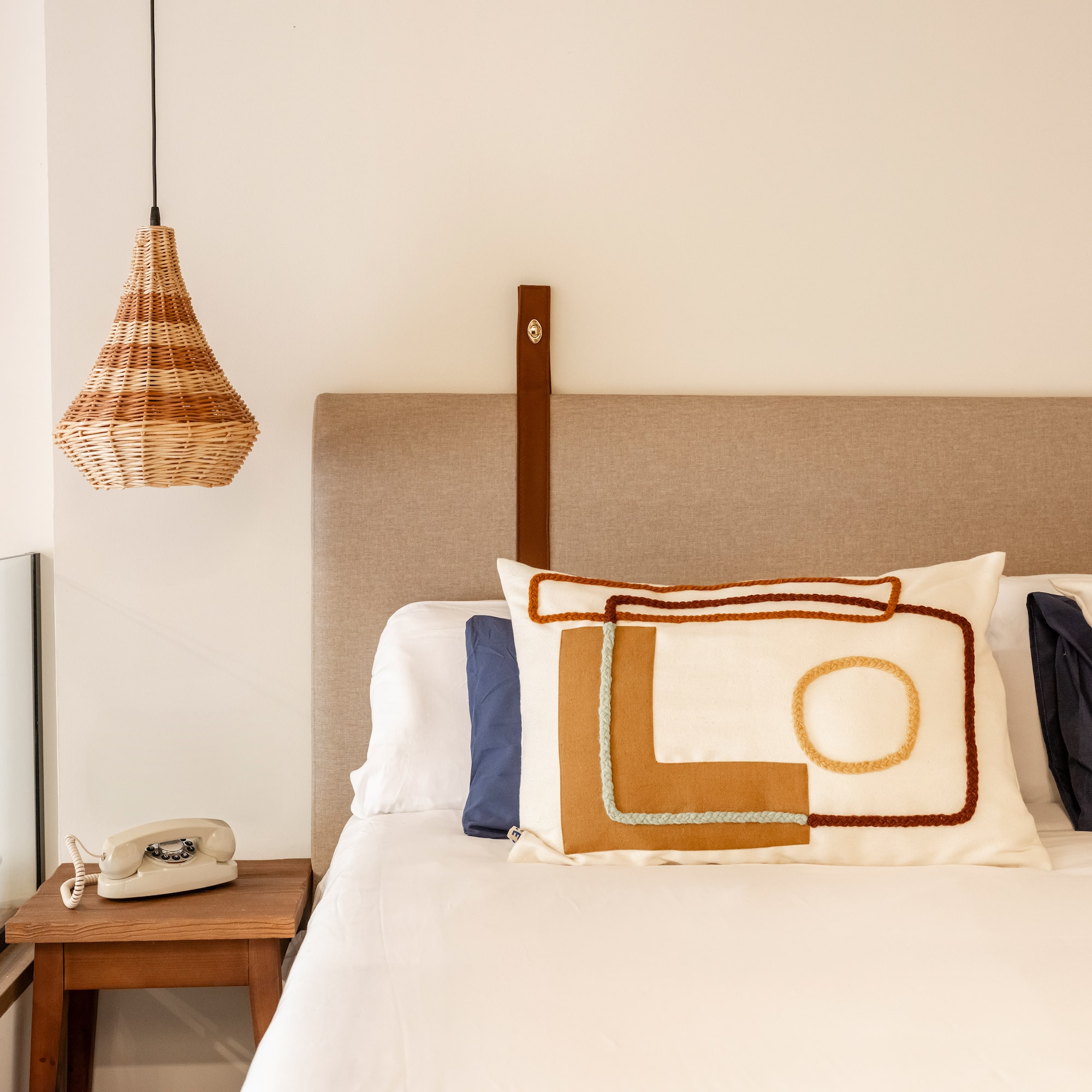 a bed with pillows and a telephone