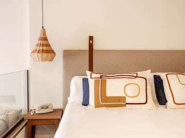 a bed with pillows and a telephone