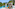 Tropical infinity pool with lounge chairs, palm trees, and rock formations.