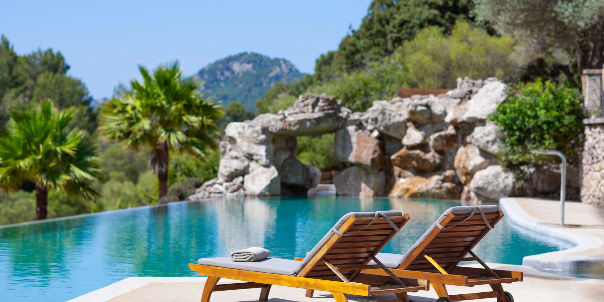 two chairs next to a pool
