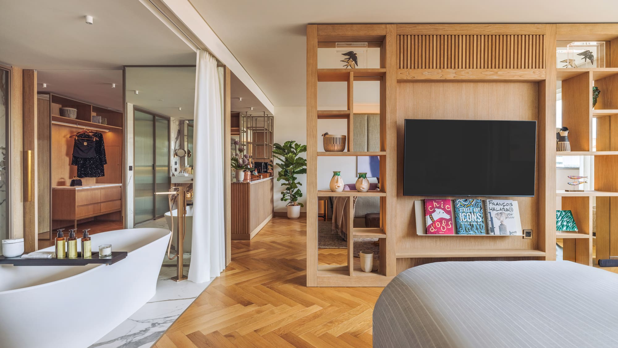 a bedroom with a tv and a bathtub