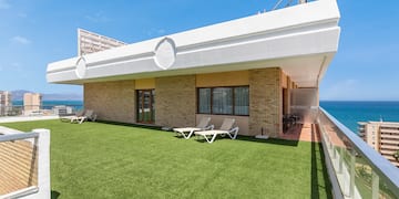 a building with lawn and chairs on the side