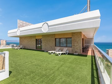 a building with lawn and chairs on the side