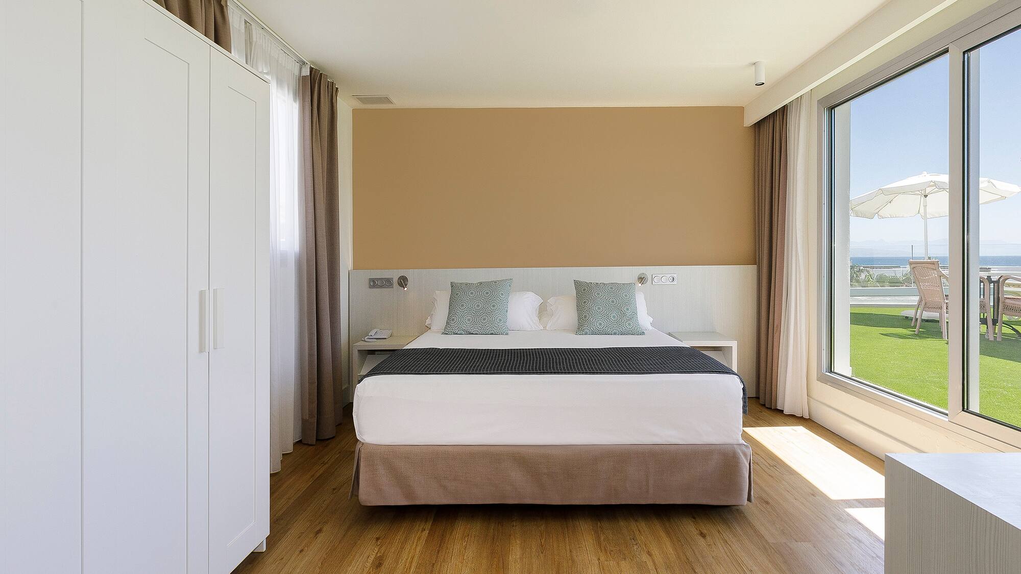 a bedroom with a bed and a large window