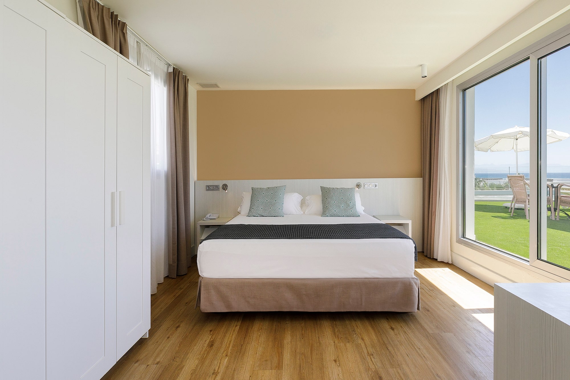 a bedroom with a bed and a large window