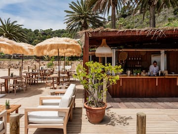 a bar with a wooden deck and umbrellas