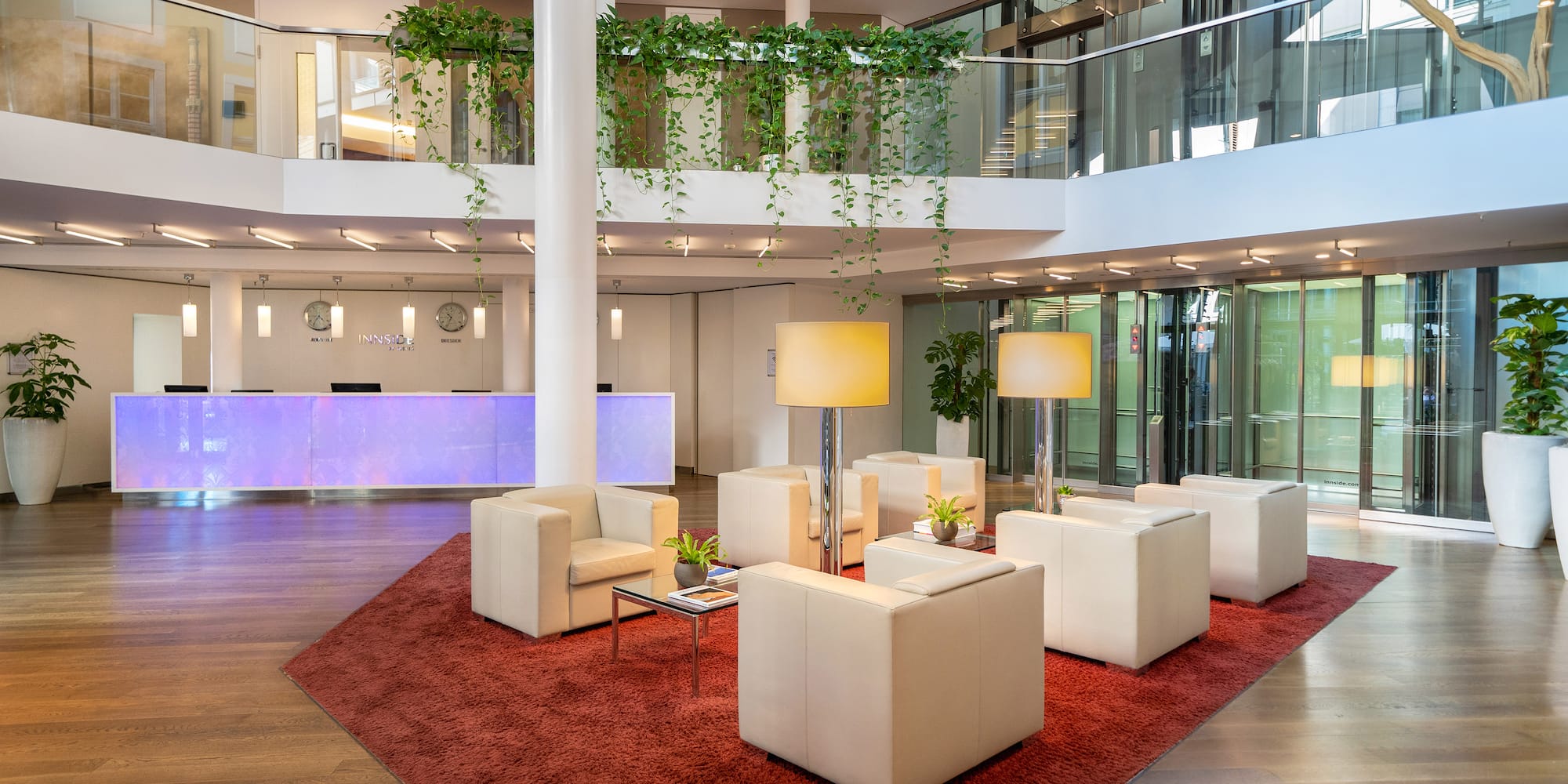 a room with white furniture and a red rug