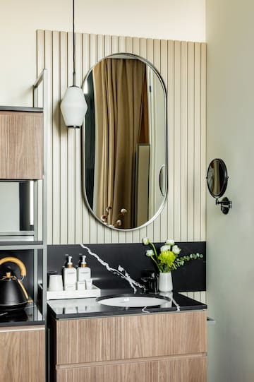 a bathroom with a mirror and a sink