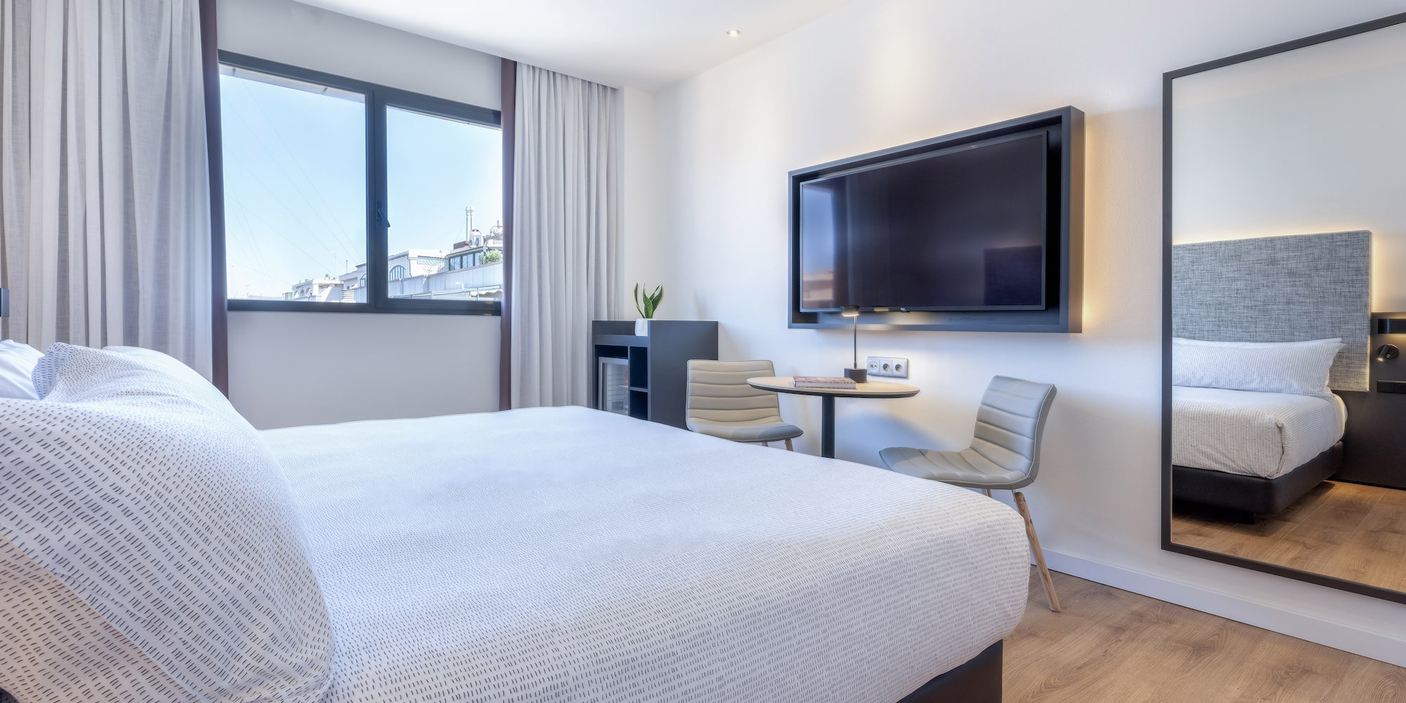 a bedroom with a large bed and a television