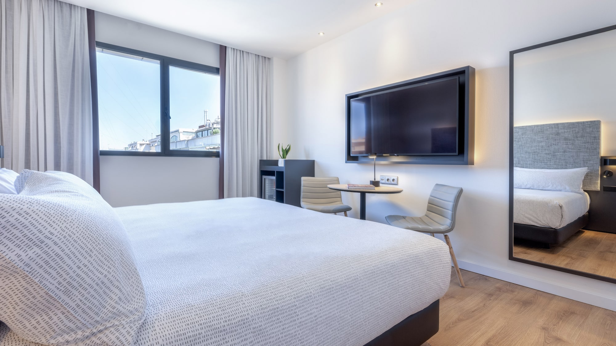 a bedroom with a large bed and a television