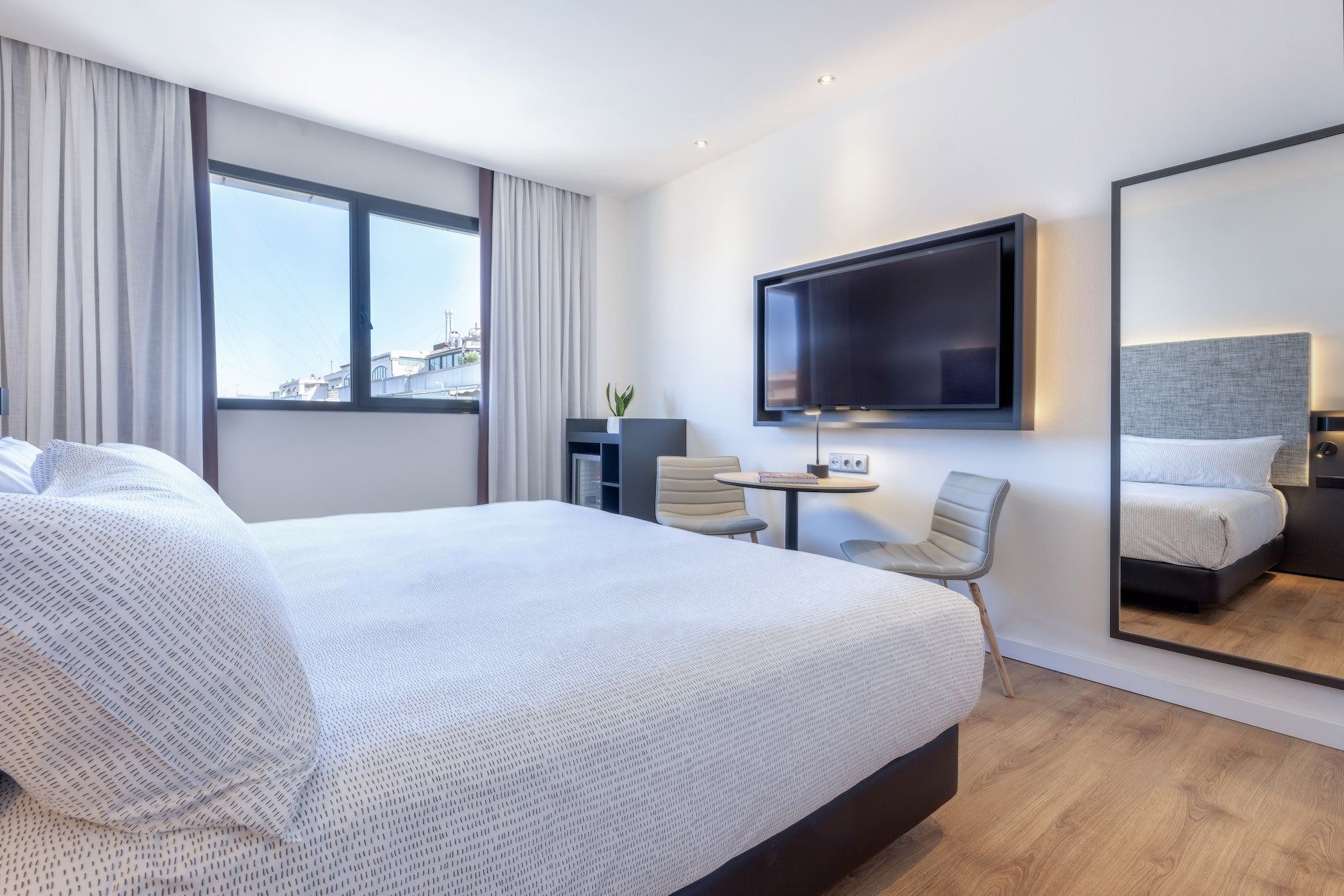 a bedroom with a large bed and a television