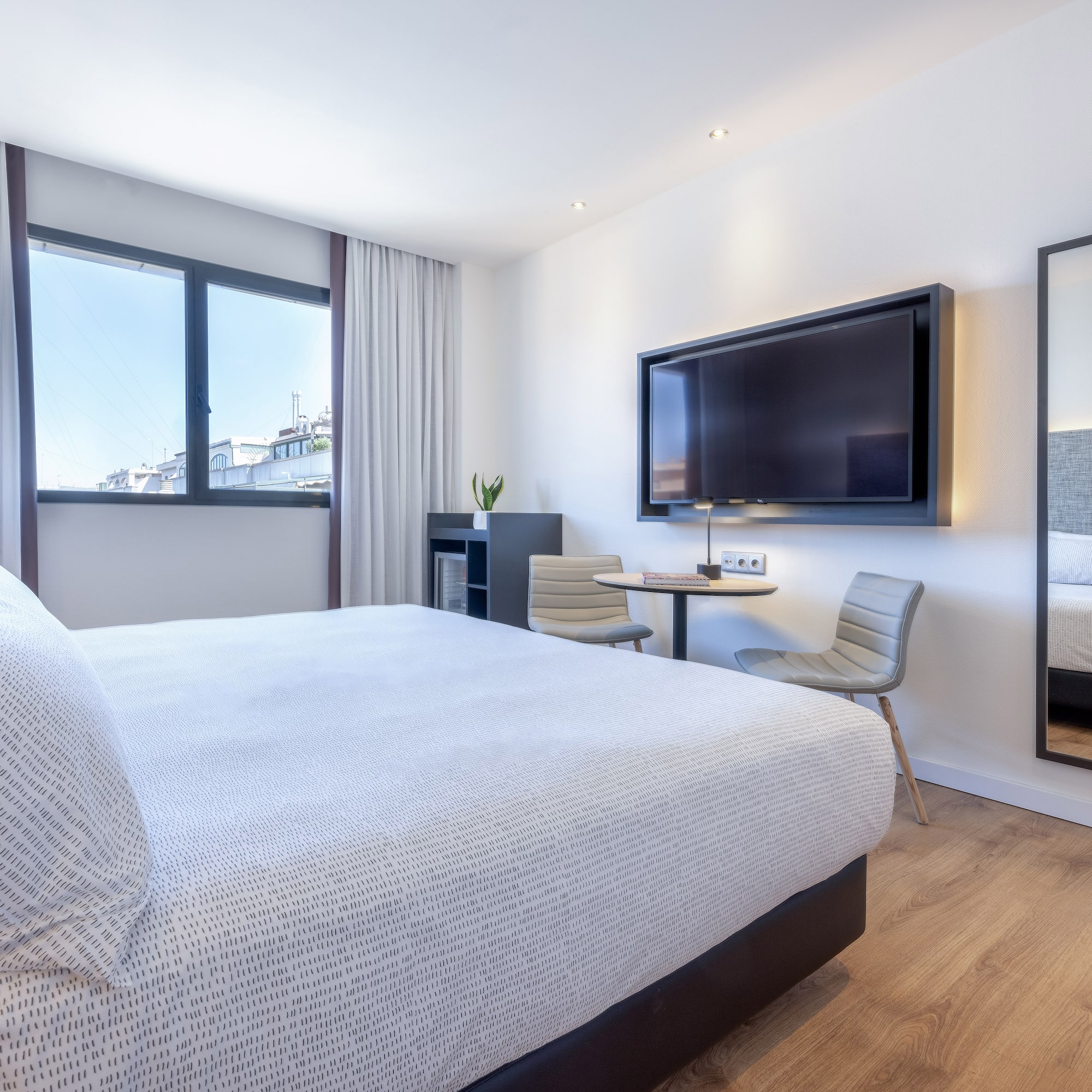 a bedroom with a large bed and a television