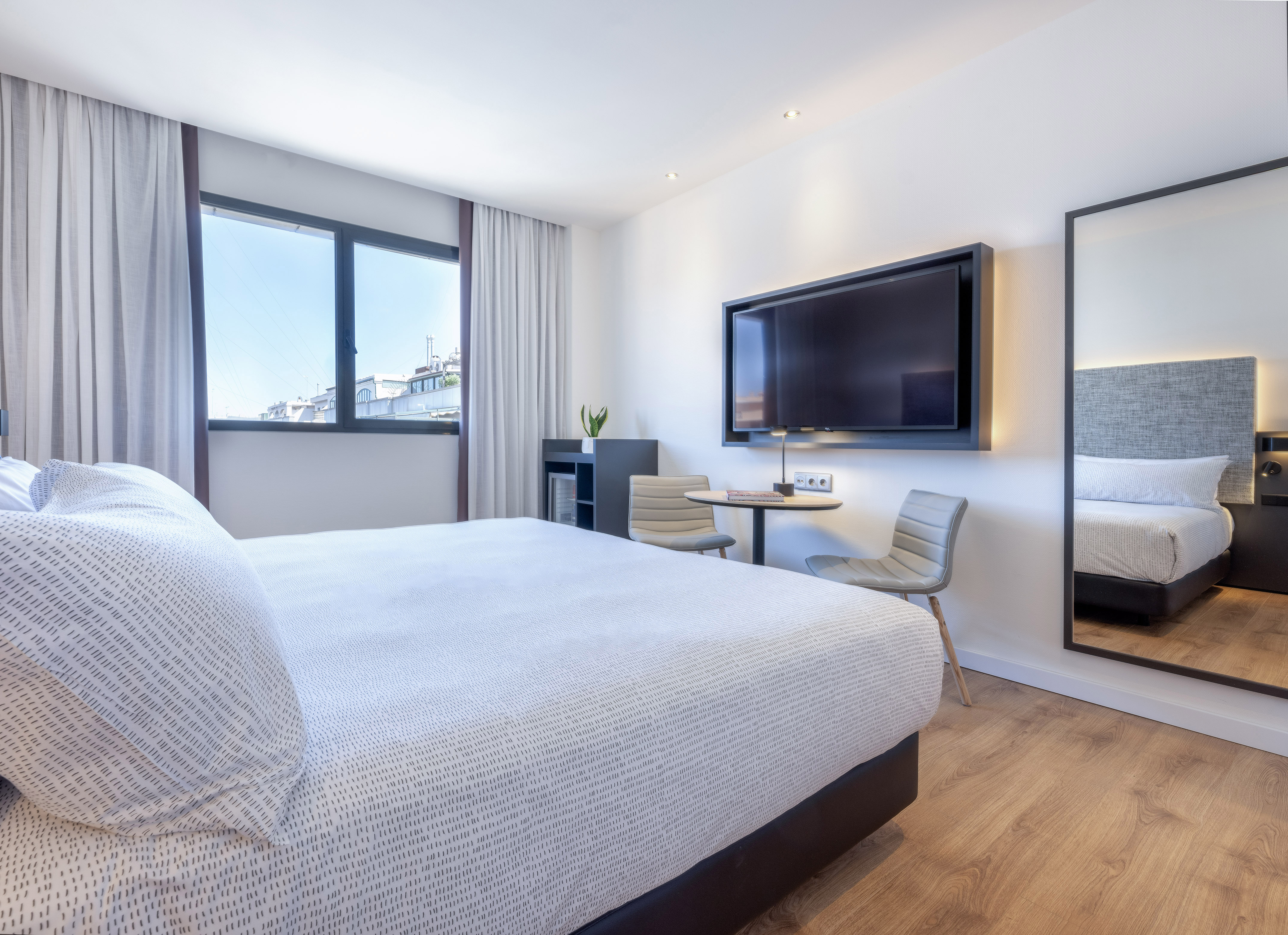 a bedroom with a large bed and a television