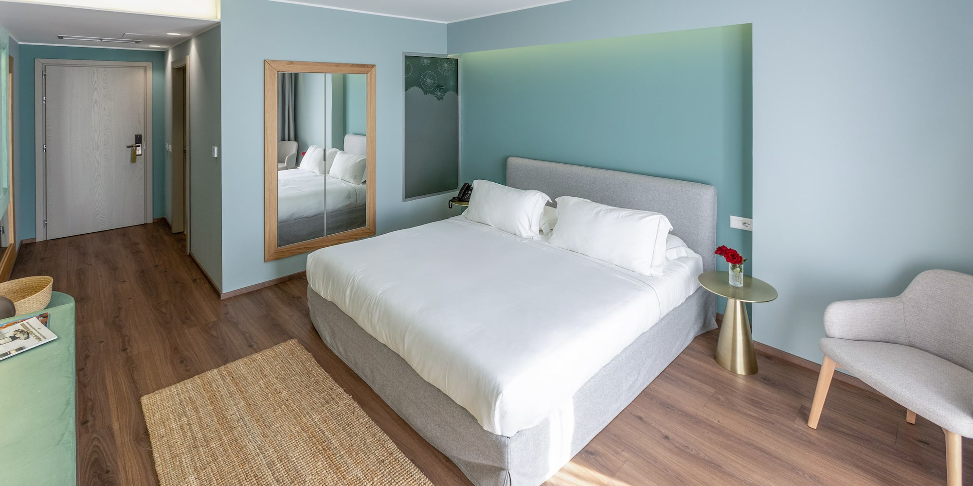 a bedroom with a bed and a mirror