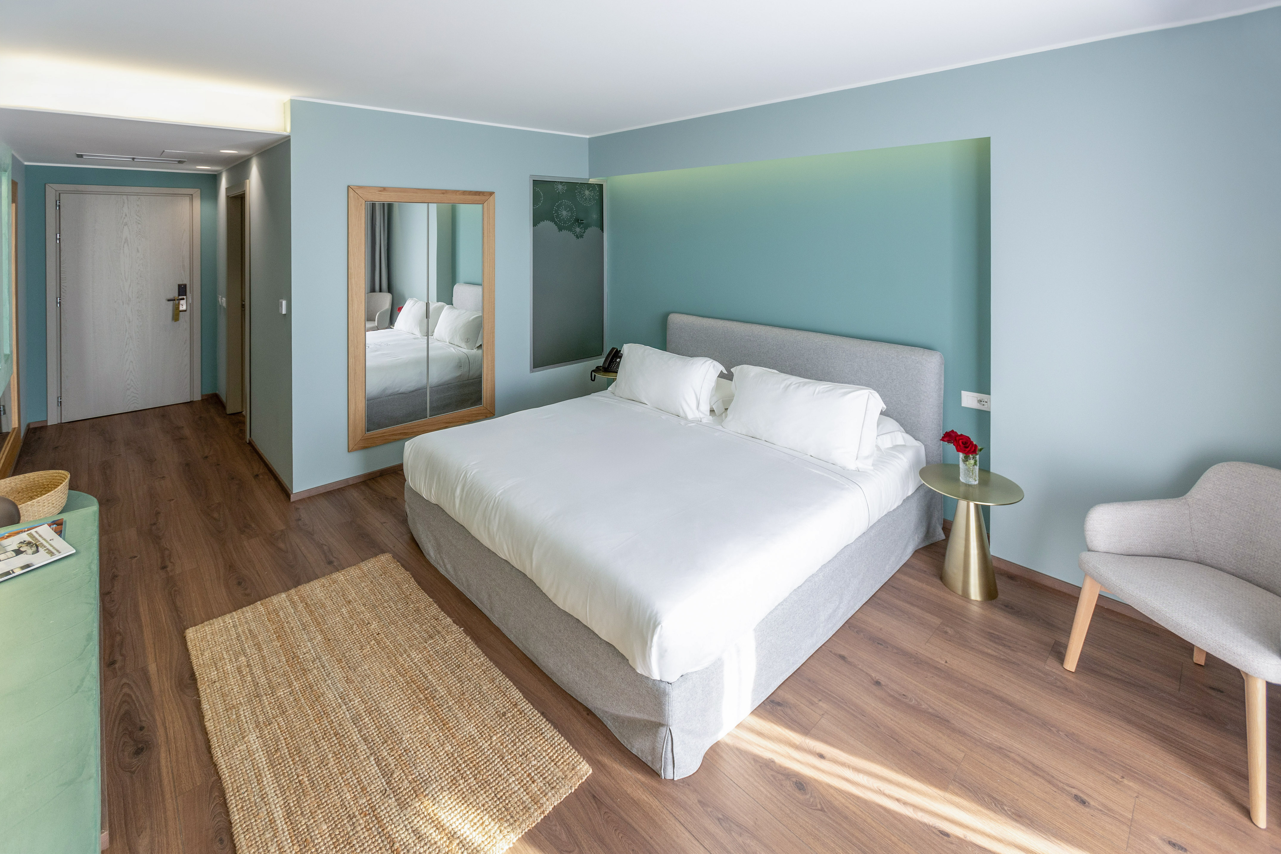 a bedroom with a bed and a mirror