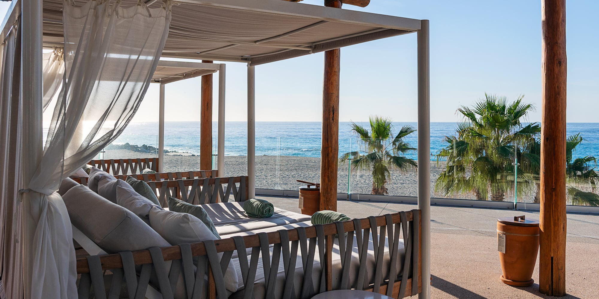 a beach with a bed and a table