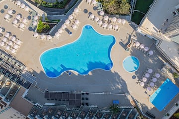 an aerial view of a pool and umbrellas