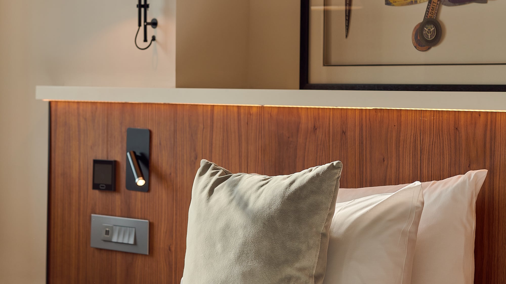 a bed with pillows and a lamp