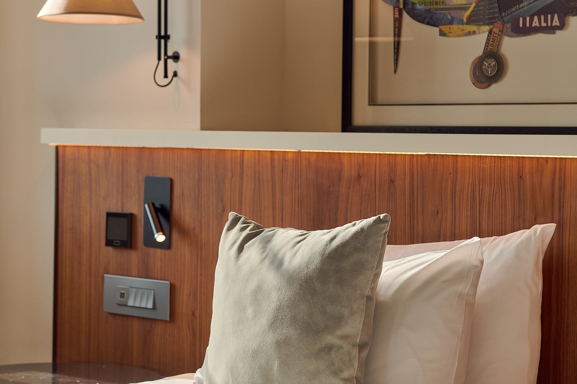 a bed with pillows and a lamp