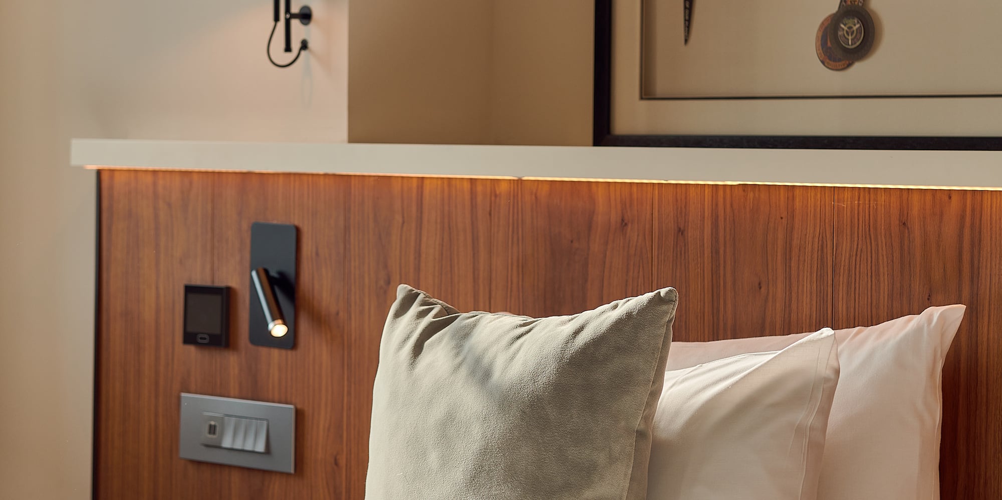 a bed with pillows and a lamp