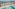 Aerial of Cancun pyramid resort on a white sand beach with turquoise ocean.