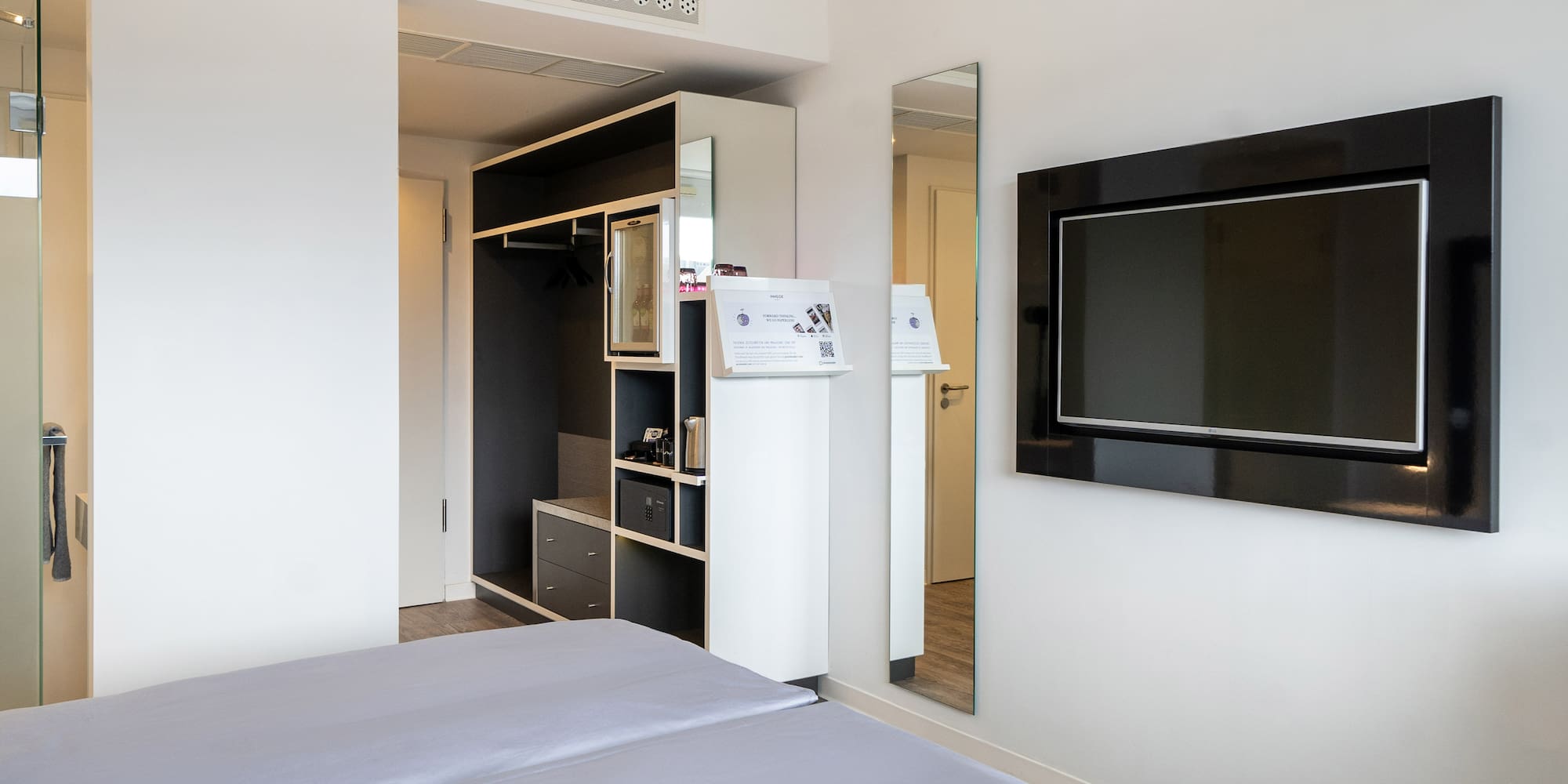 a room with a bed and a tv