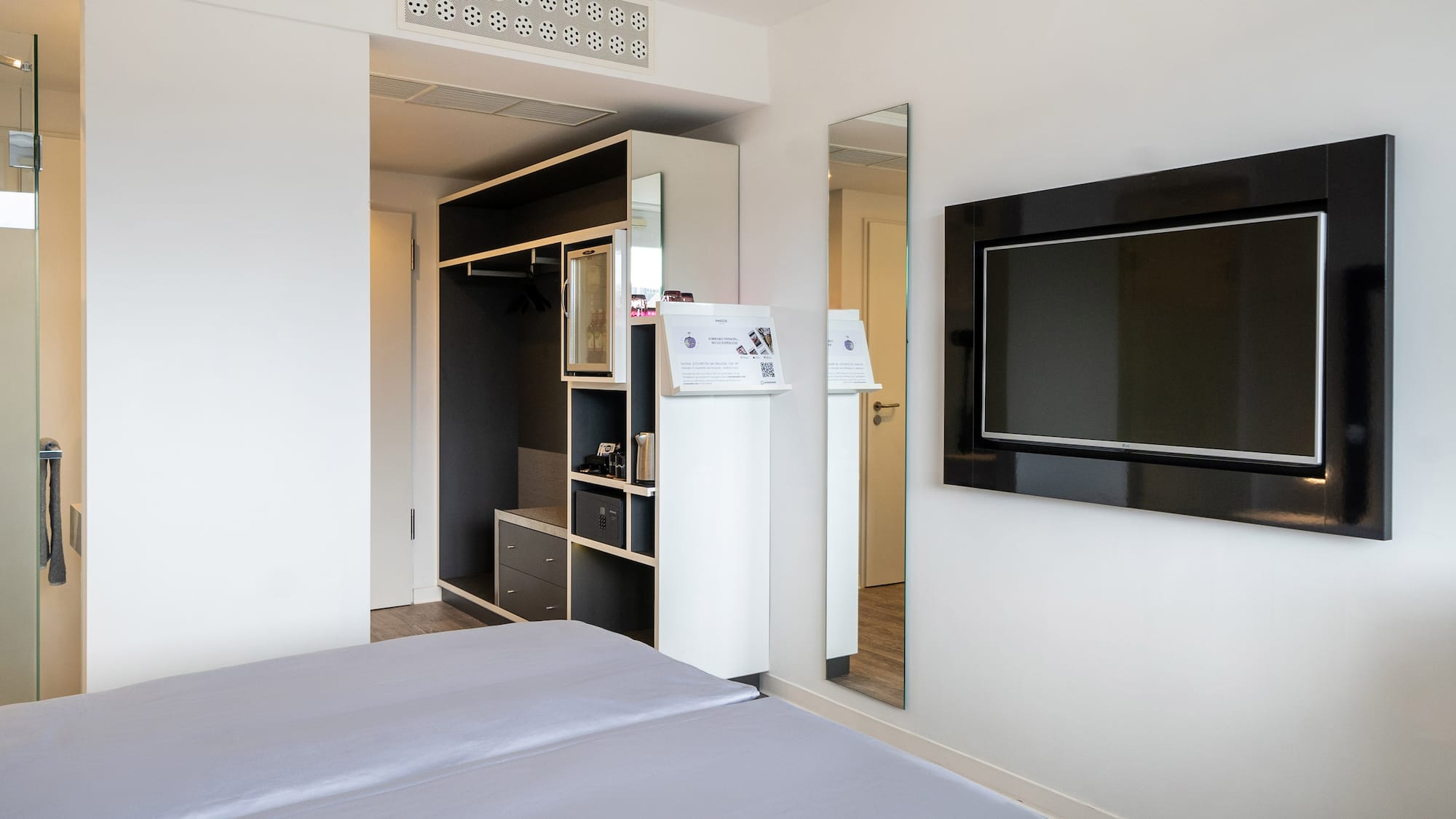 a room with a bed and a tv