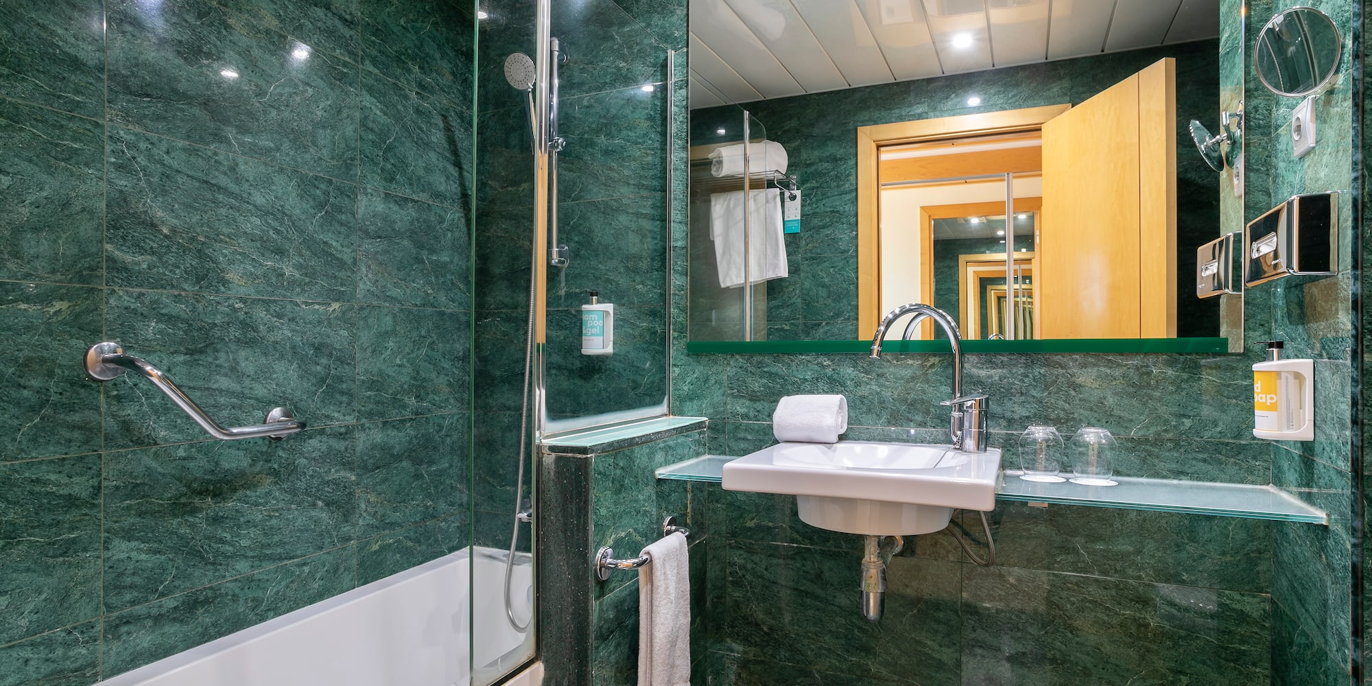 a bathroom with green tiles