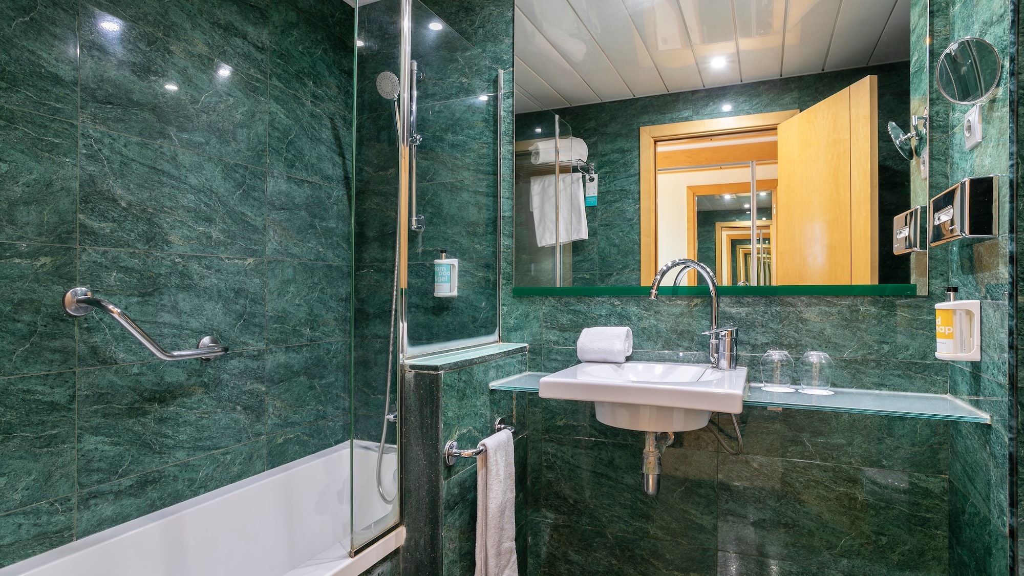 a bathroom with green tiles