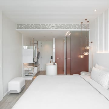 a bedroom with a sink and a bed