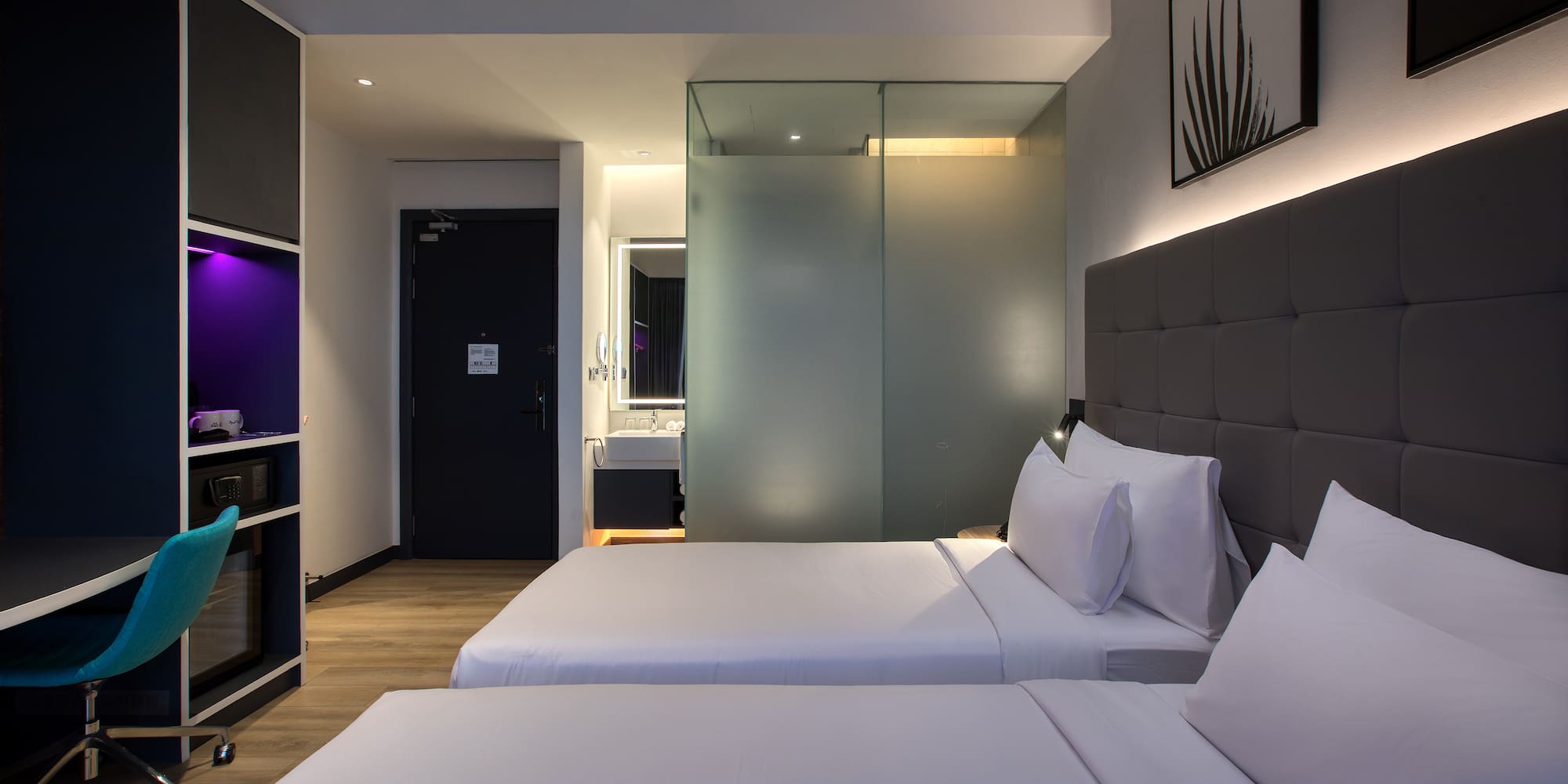 a room with two beds and a glass door