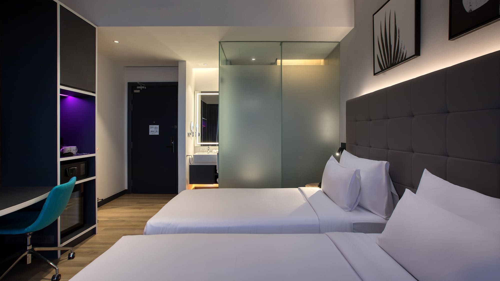 a room with two beds and a glass door