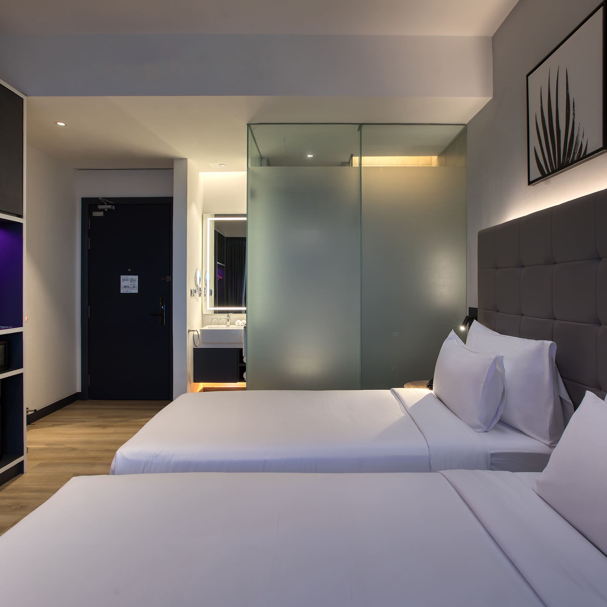 a room with two beds and a glass door