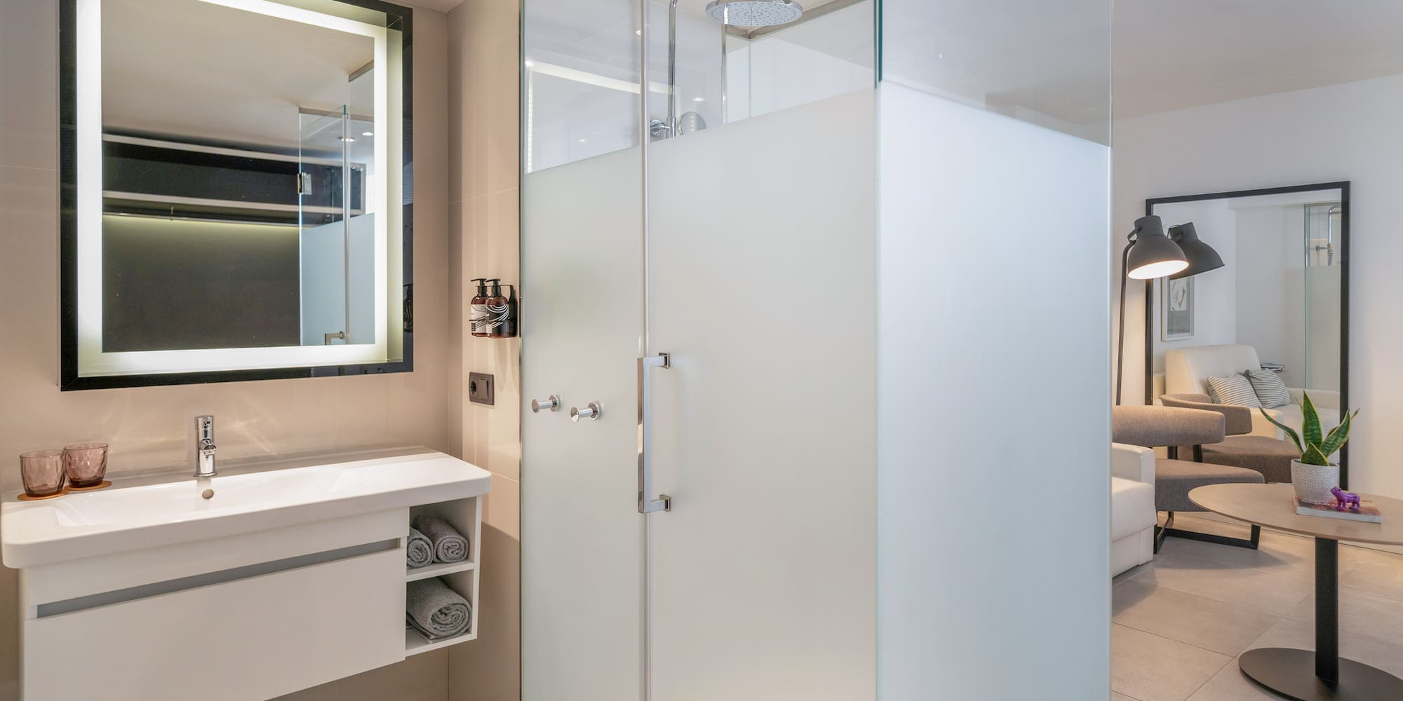 a bathroom with a glass shower and sink