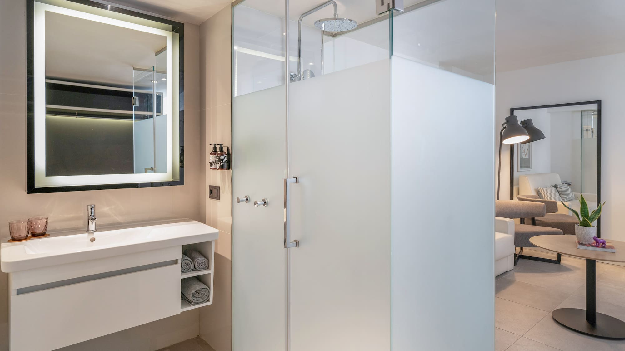a bathroom with a glass shower and sink