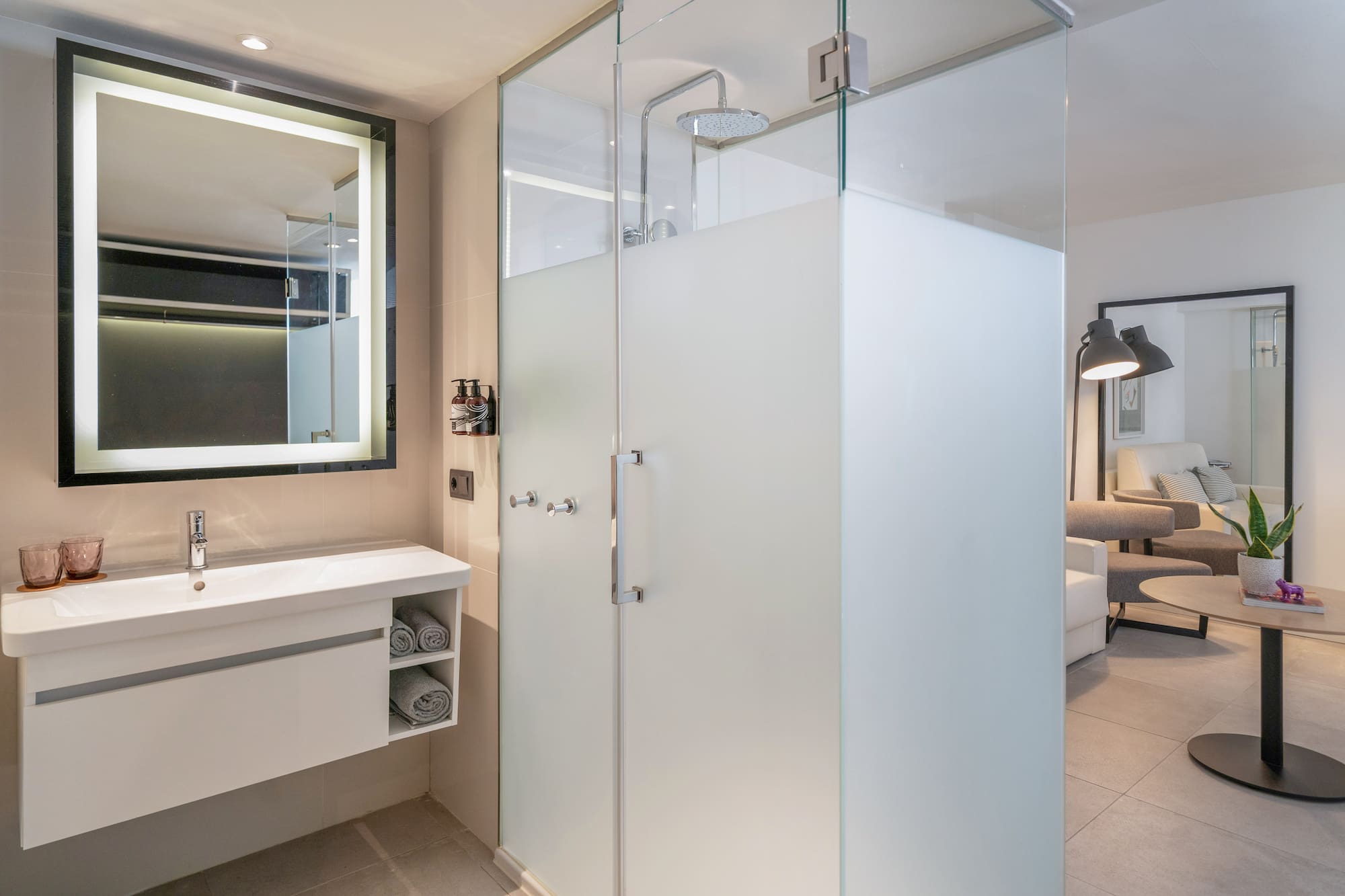 a bathroom with a glass shower and sink