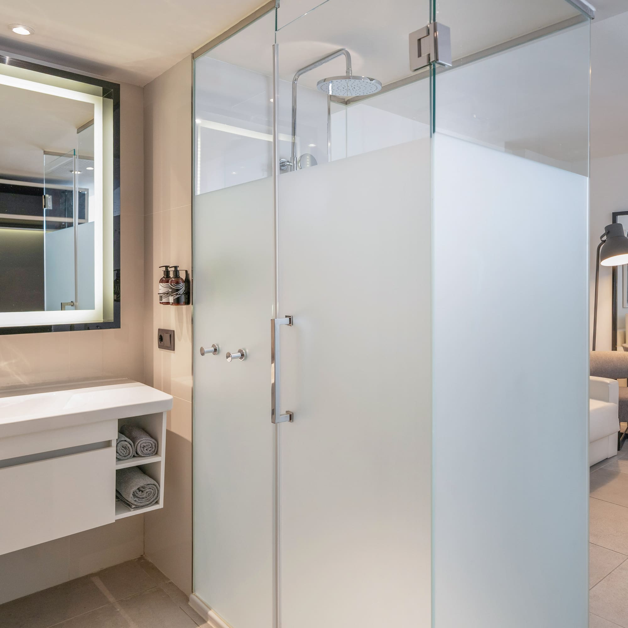 a bathroom with a glass shower and sink