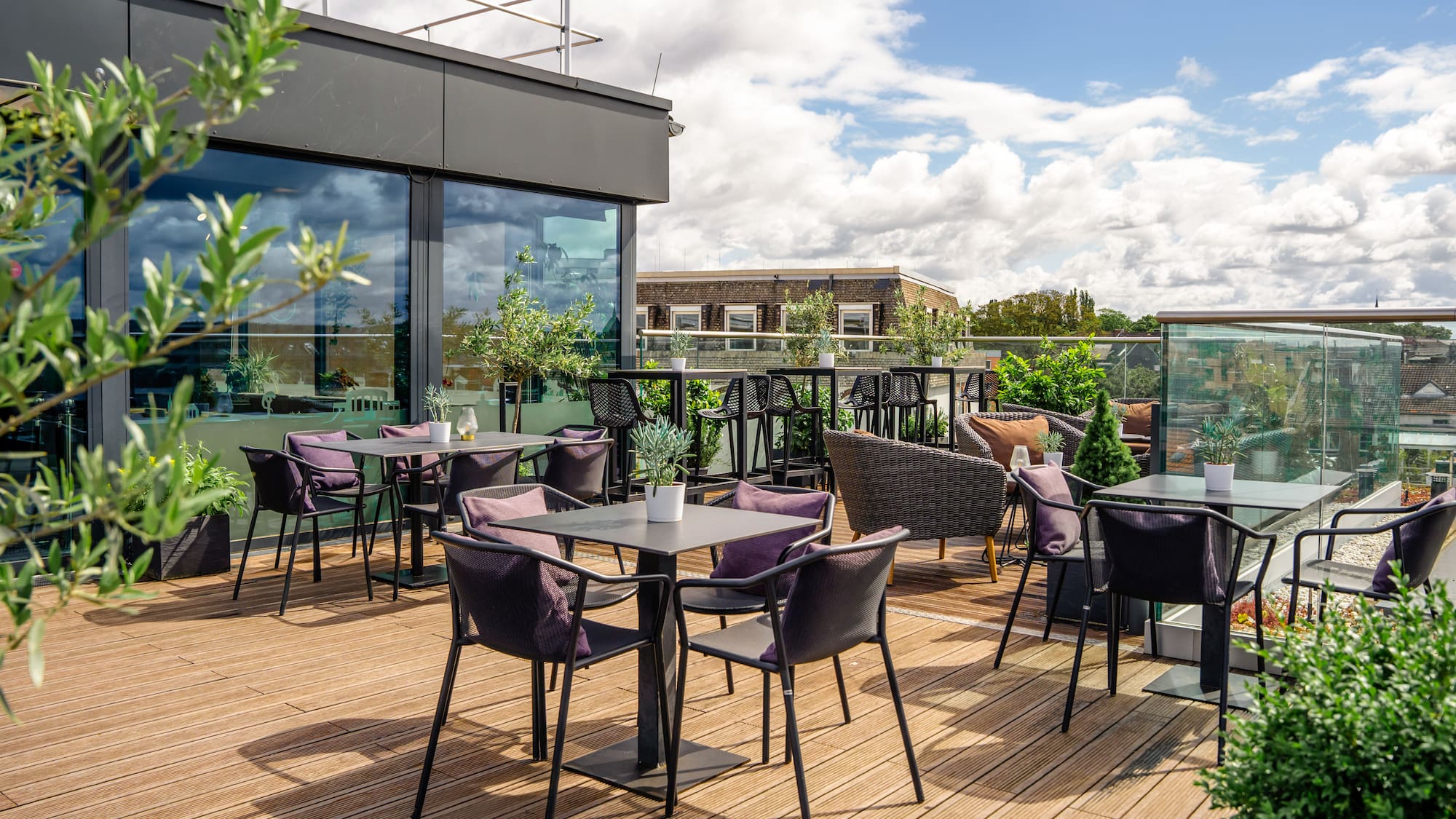 a patio with tables and chairs on a deck