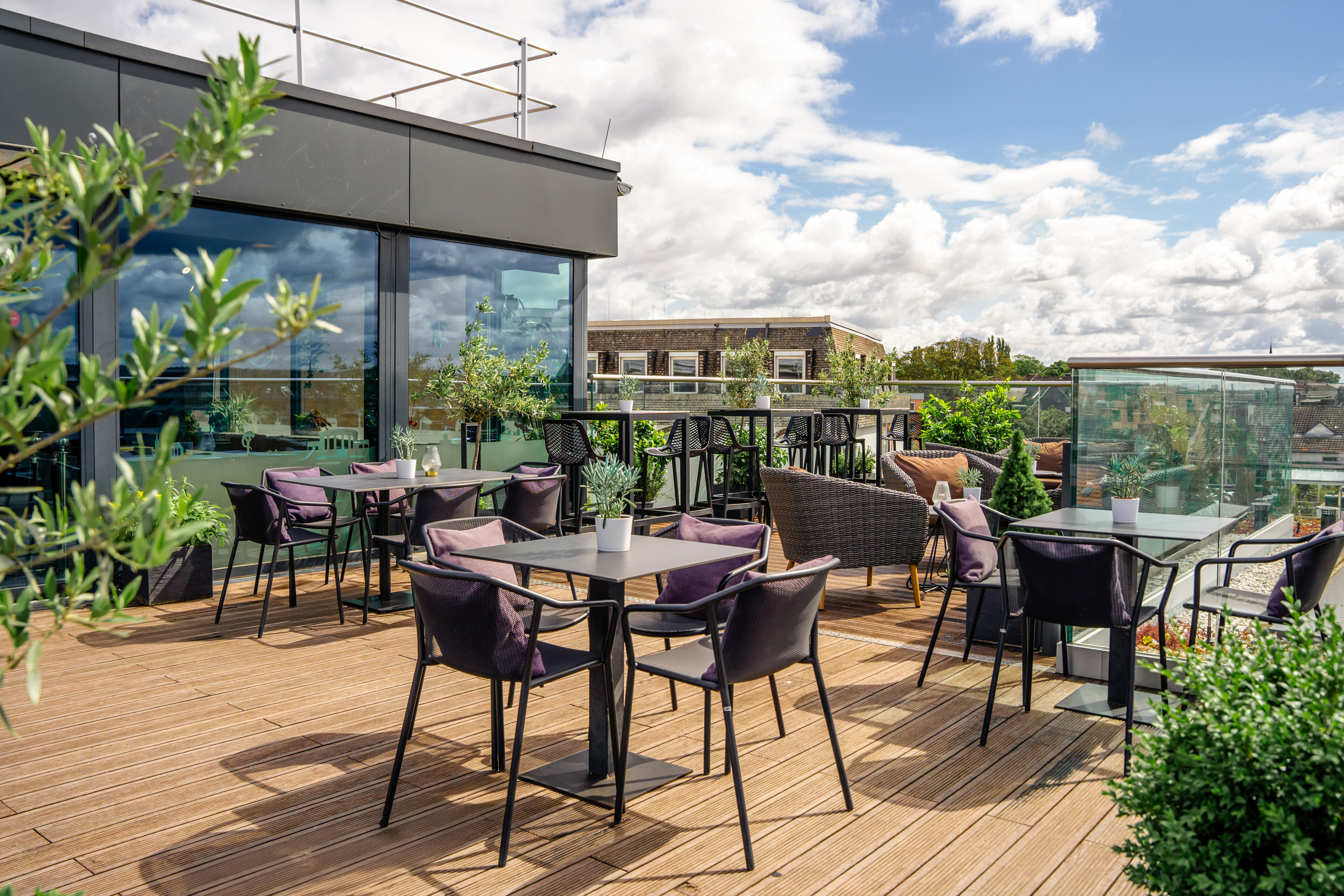 a patio with tables and chairs on a deck