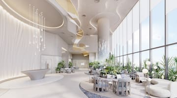 a room with tables and chairs and plants