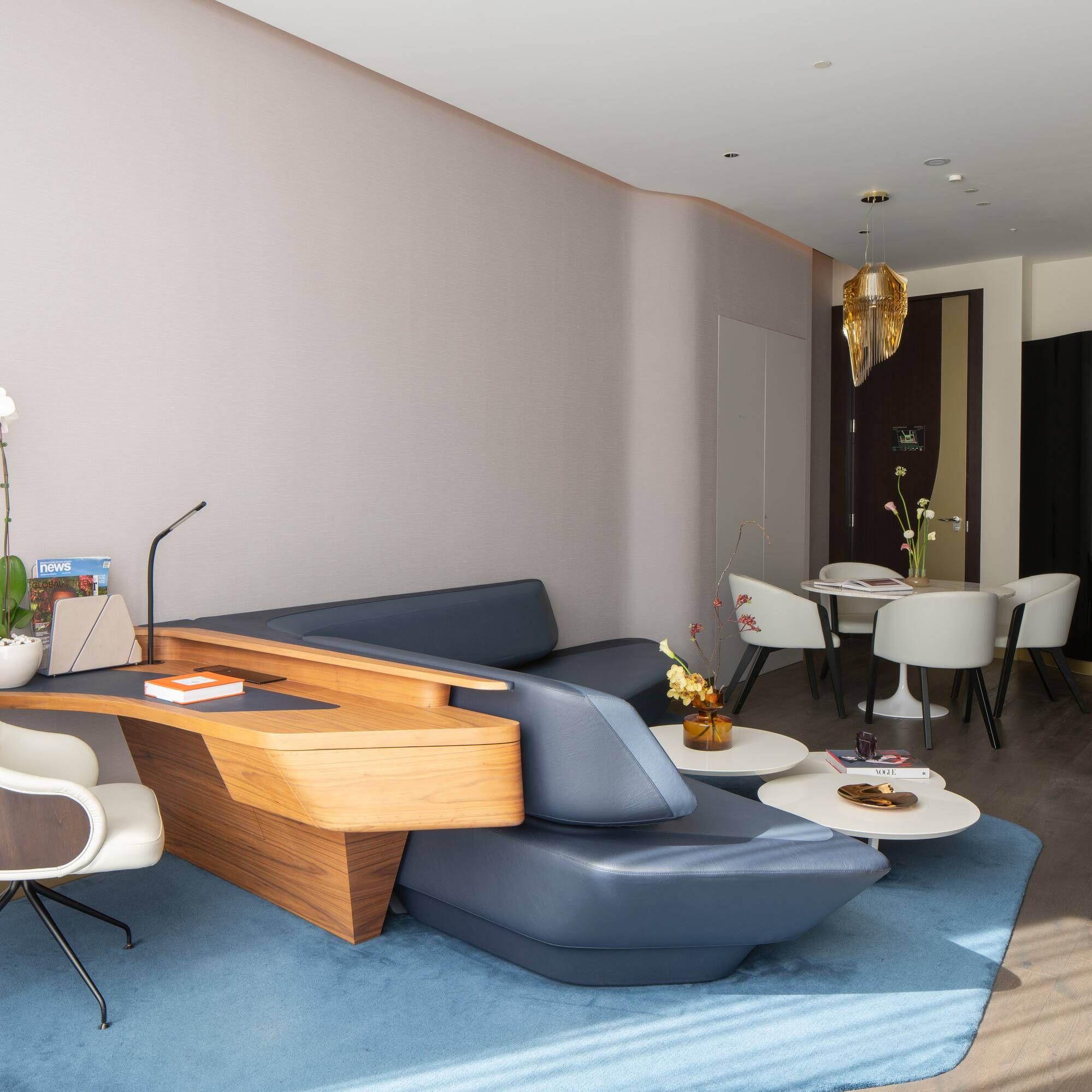 a room with a couch and chairs