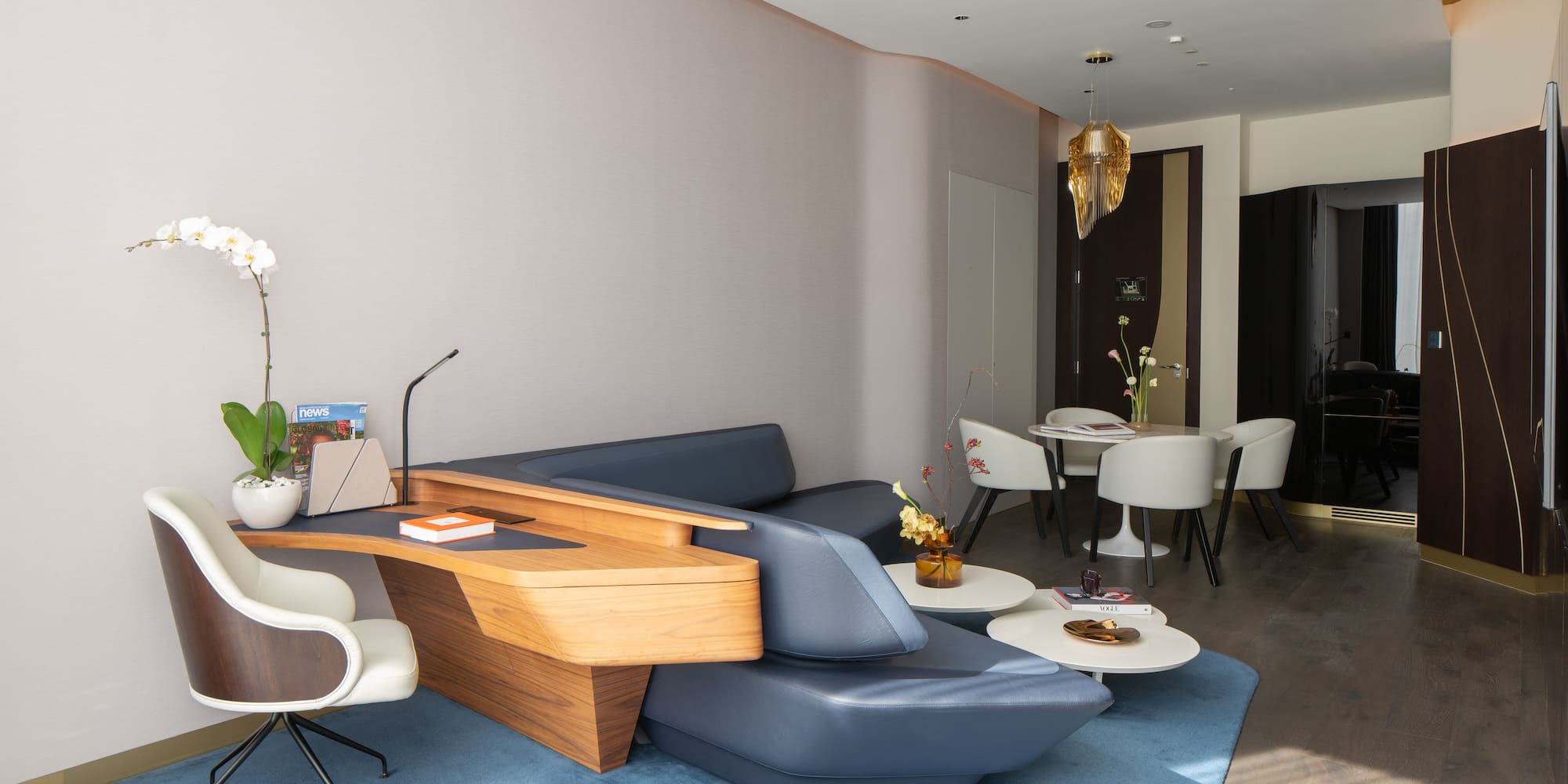 a room with a couch and chairs